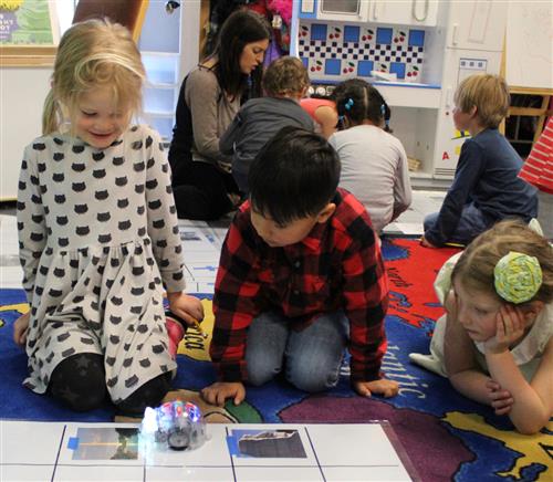 Kindergarteners with "B-bots" robots 
