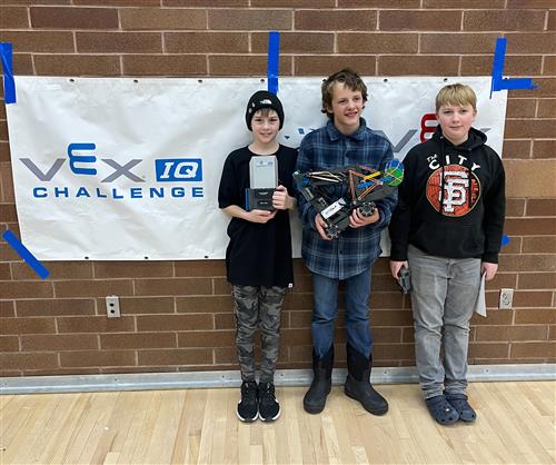  Noah Nielson, Mason Vanderbeek, Jacob Blacker stand with trophy