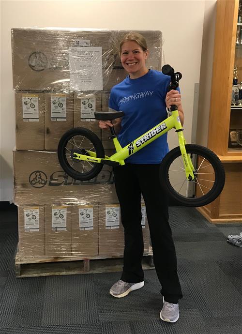 Mrs. Flavin with the first Strider bike in our fleet of 20! 
