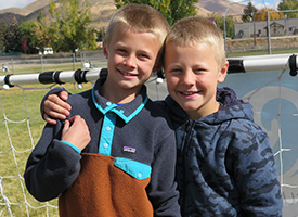  Two students in front of a soccer goal