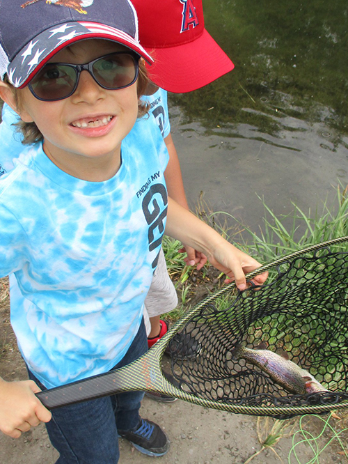 student with fish in a net 