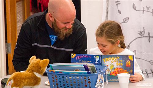 dad reading with child 