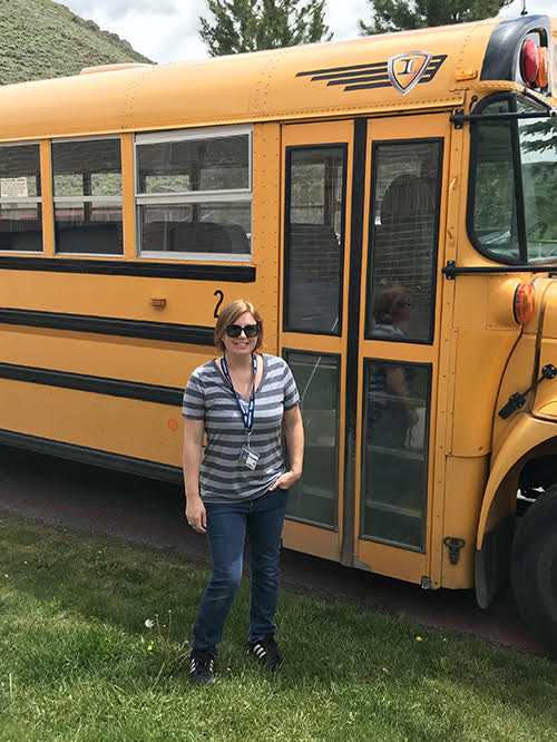 bus driver standing in front of bus 