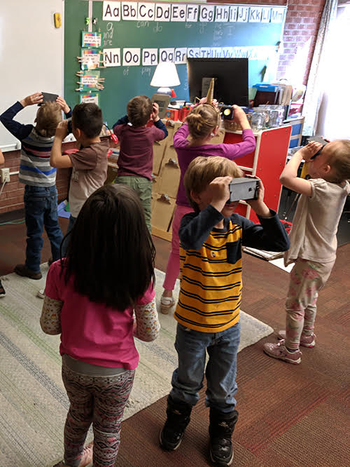 students looking through viewfinder 
