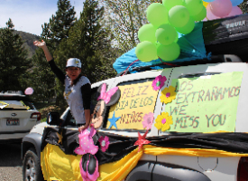 People in cars during a parade