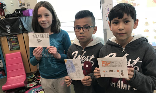 Students showing off thank you cards 
