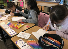  students writing thank you cards in classroom